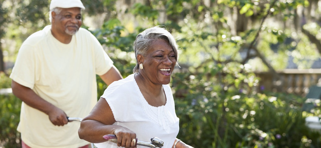 Senior couple riding bikes together in a park